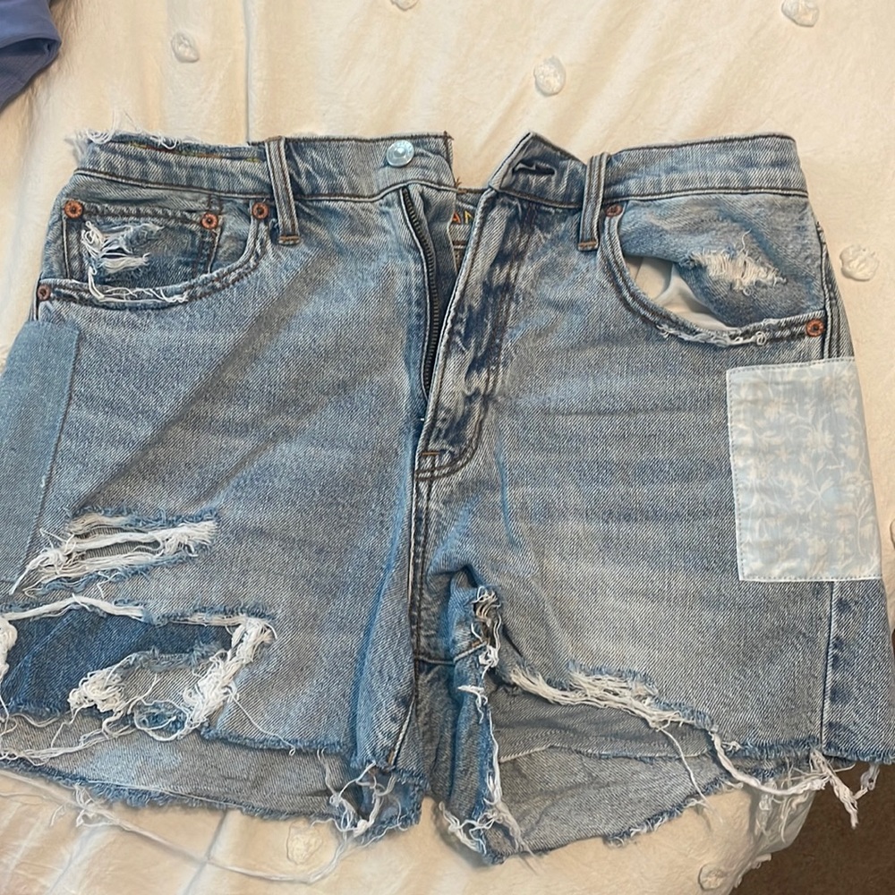 Blue Jean shorts with distressed details.